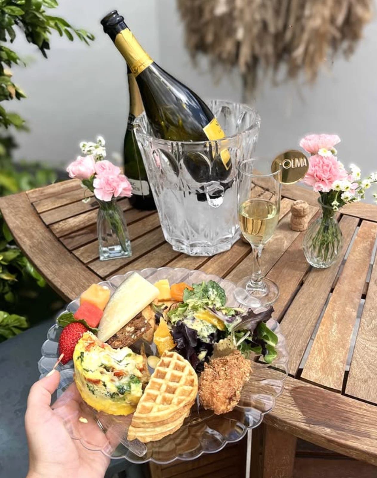 A plated celebration brunch with champagne and florals