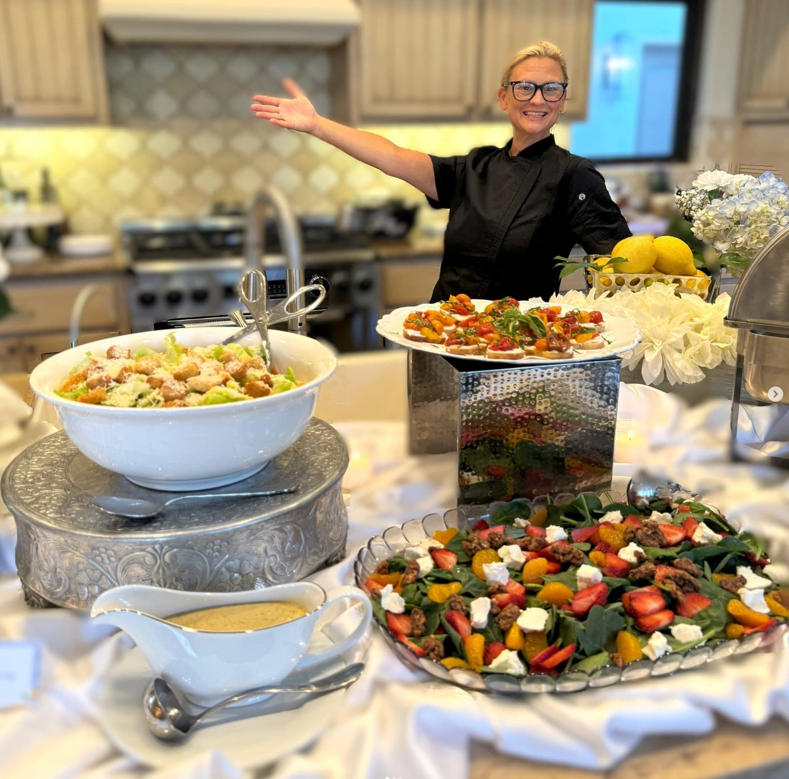 Emily presenting a buffet of salads and bruschetta at a home event
