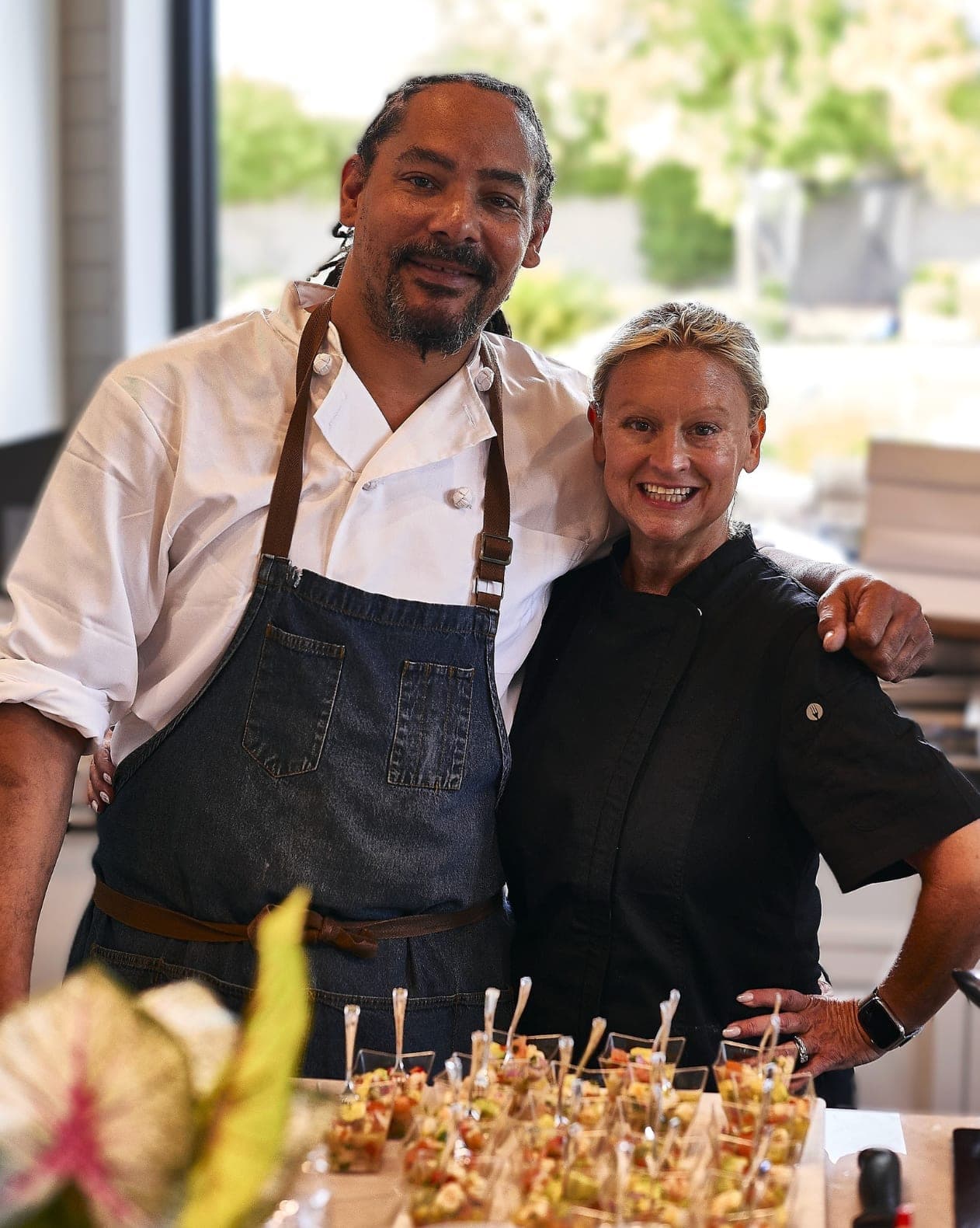 Two staff members plating passed appetizers at an event